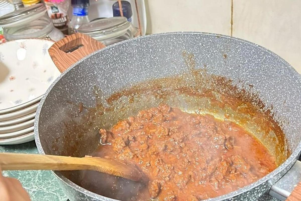 a pot of food with a wooden spoon in it
