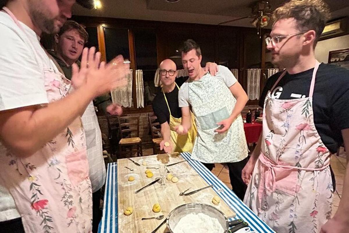a group of men standing around a table with food
