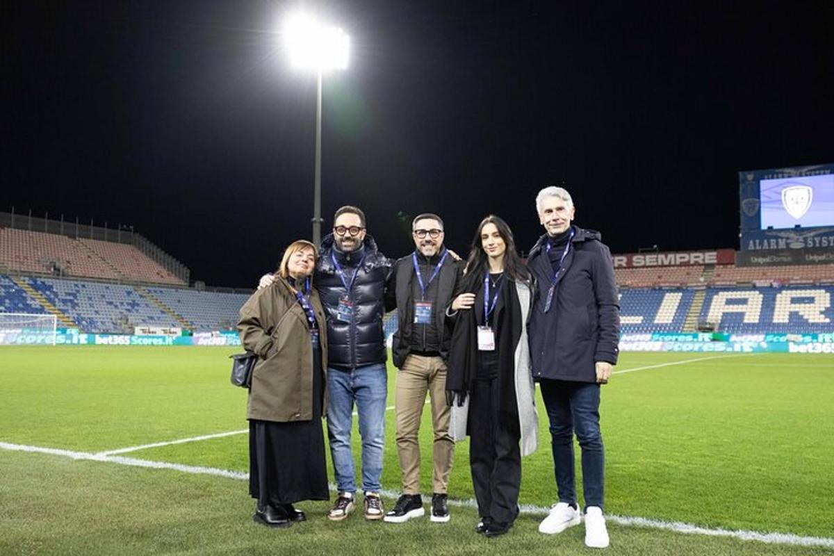 a group of people standing on a soccer field