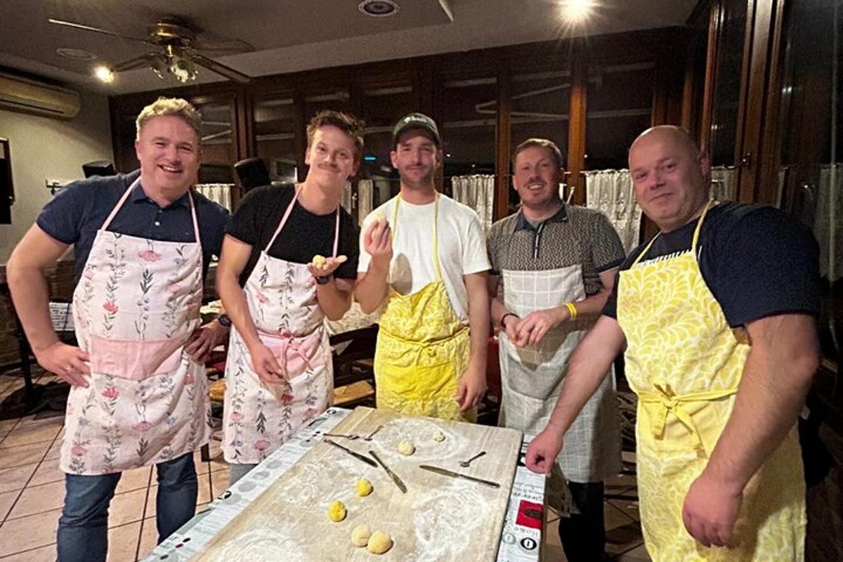 a group of men in aprons standing around a table