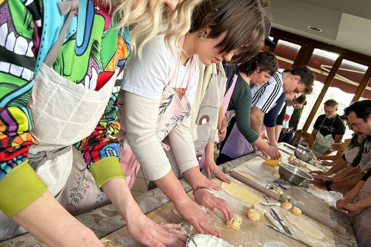 a group of people standing around a table preparing food