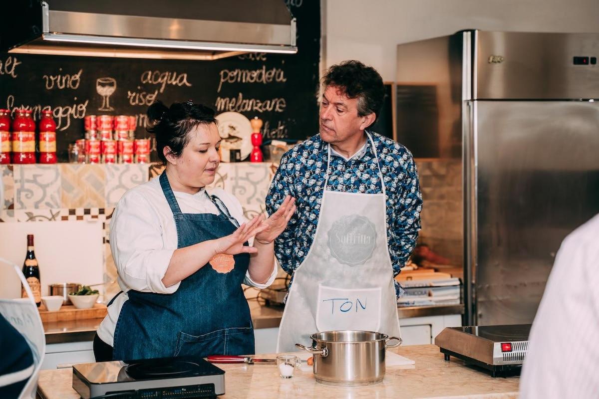 a man and a woman standing in a kitchen