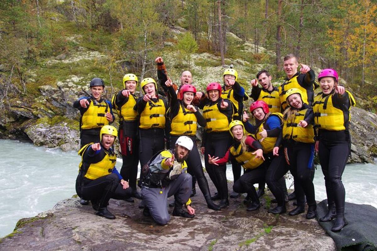 a group of people posing for a picture on a river