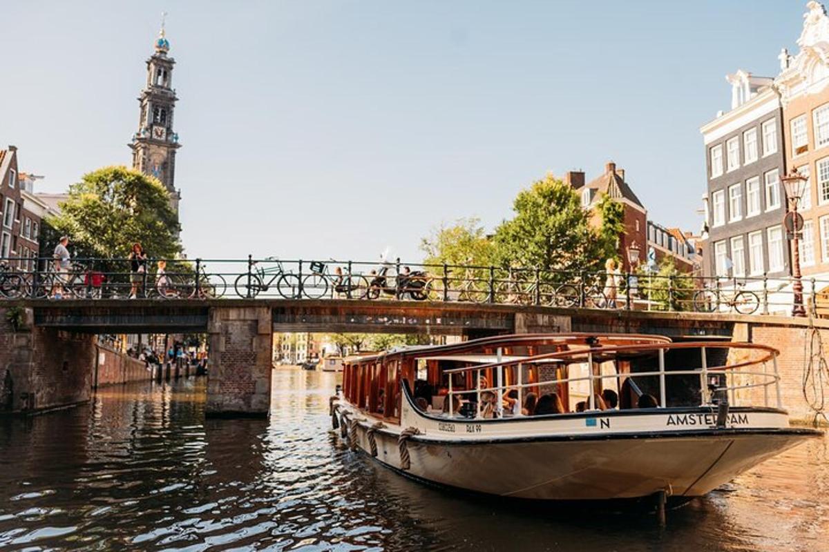 a boat traveling down a river under a bridge