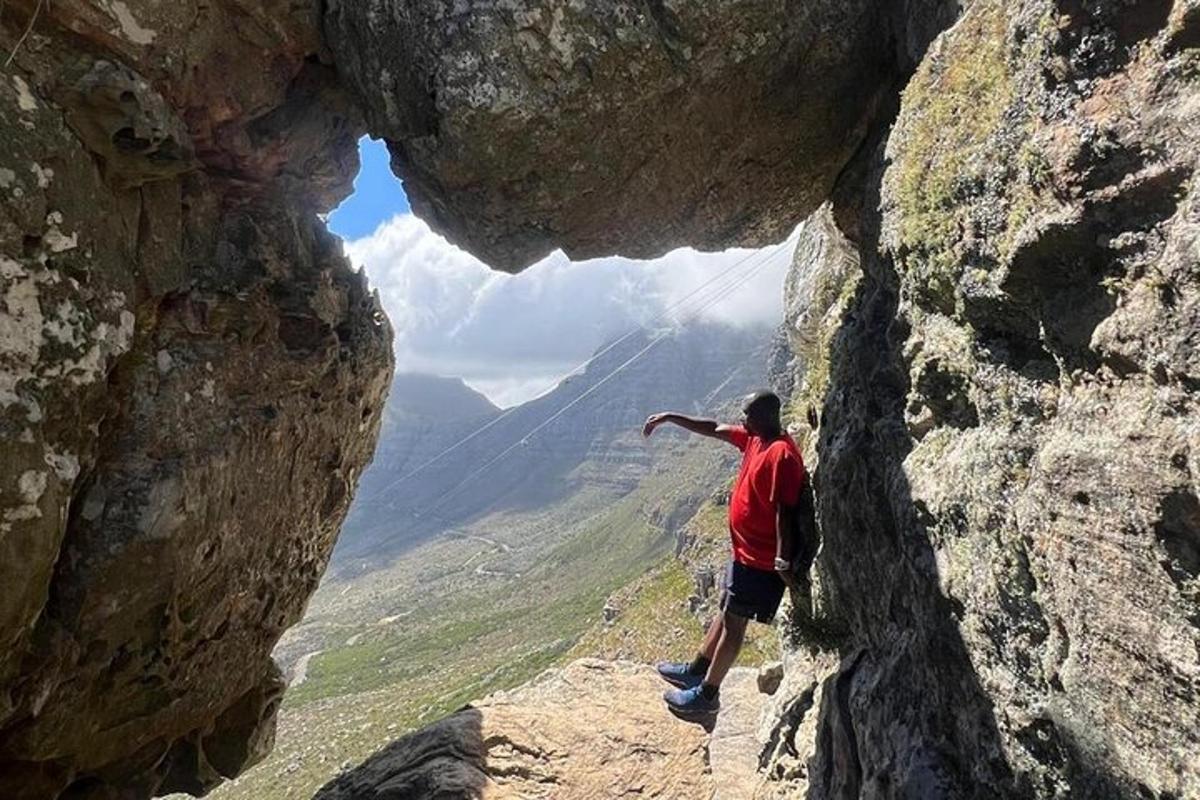 a man is standing inside of a rock formation