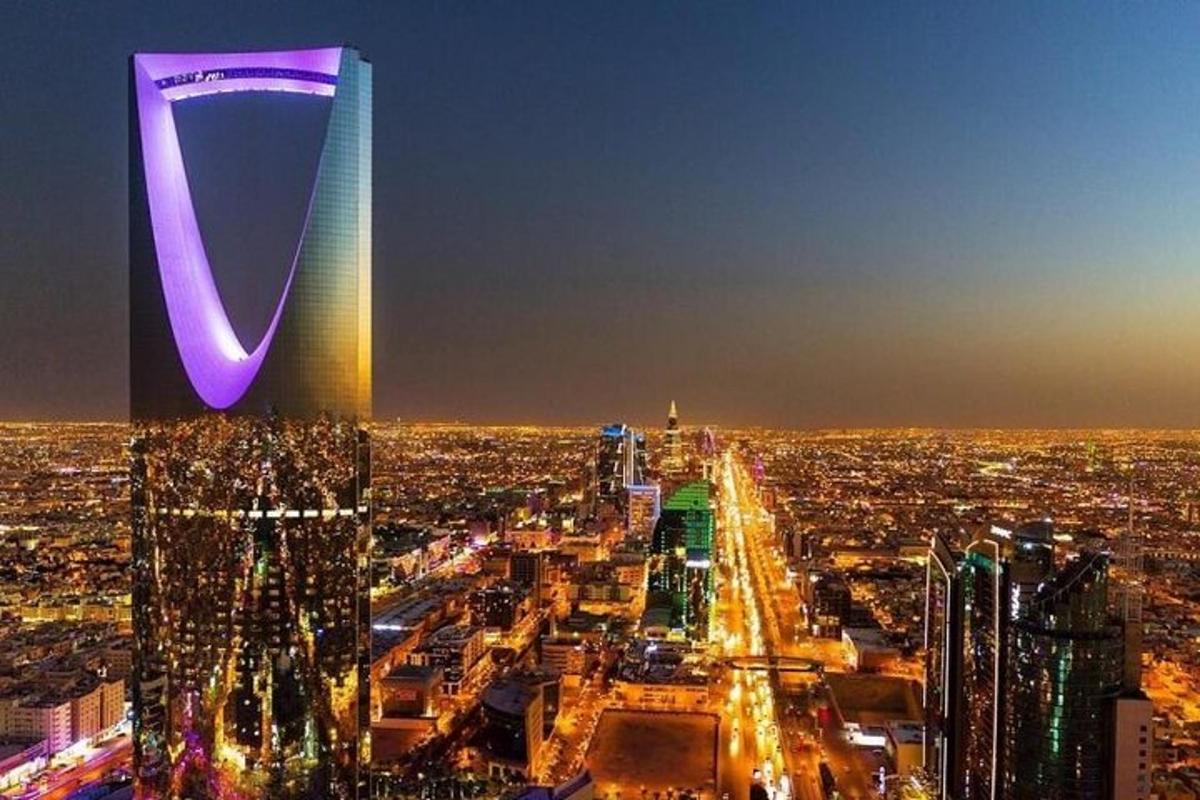 a view of a city at night with a tall building