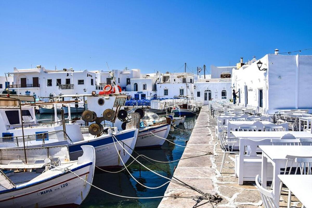 a group of boats docked in a harbor with buildings