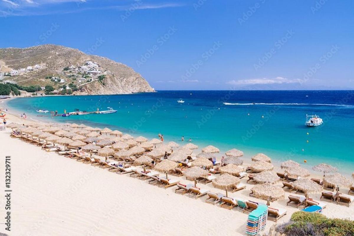 a beach with umbrellas and chairs and the ocean