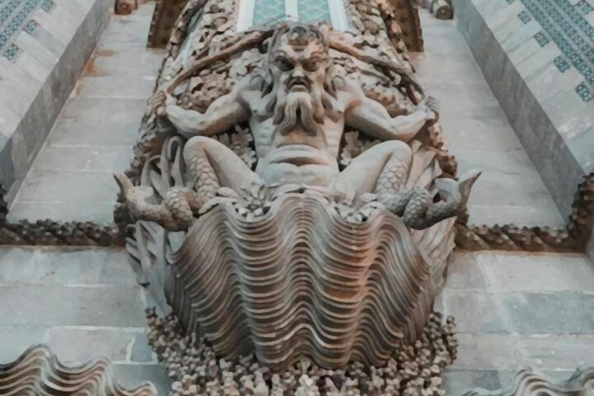 a statue of a mermaid on the side of a building