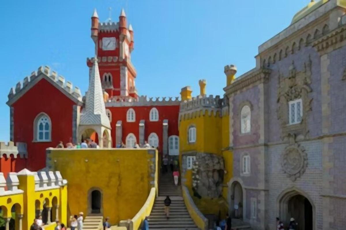 a building with a staircase in front of a castle