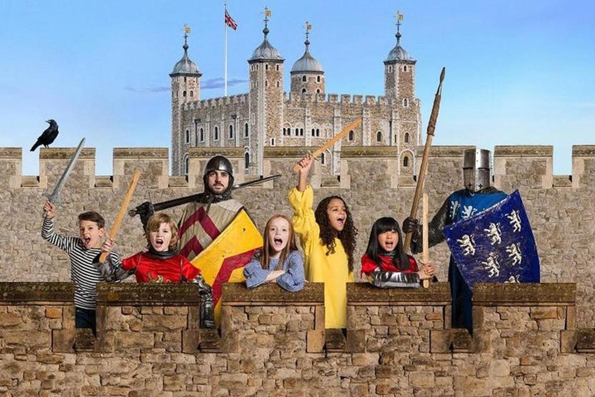 a group of people standing on a wall in front of a castle