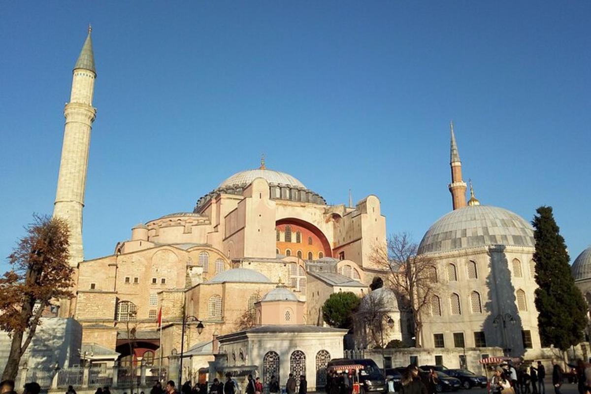 a building with two mosques and a statue in front of it