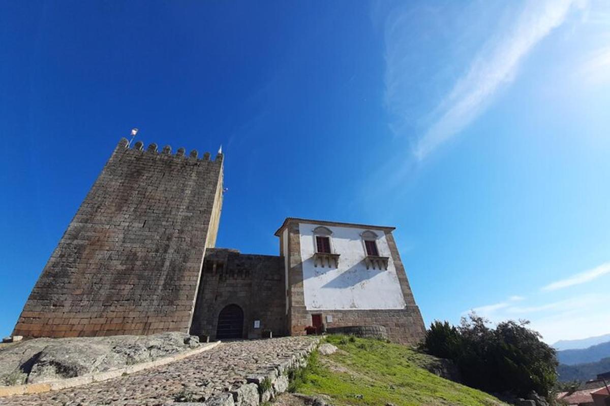 a building with a clock tower on top of a hill
