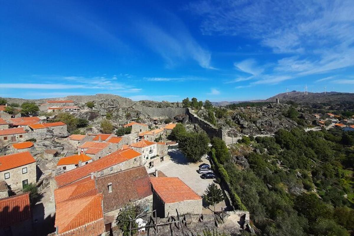 an aerial view of a village with orange roofs