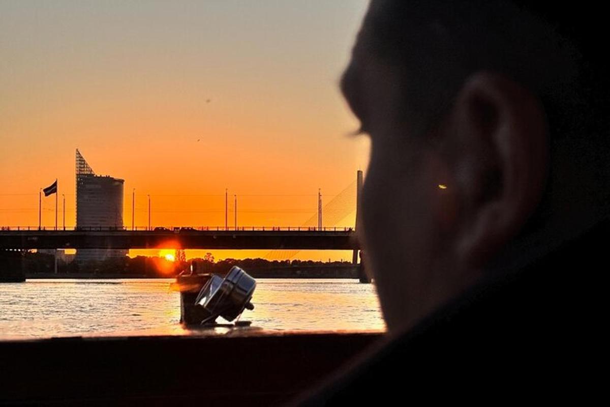 a person looking out of a window at the sunset