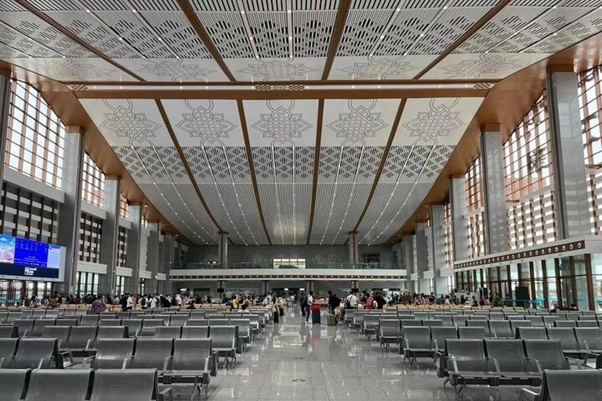 a large hall with chairs and people in an airport