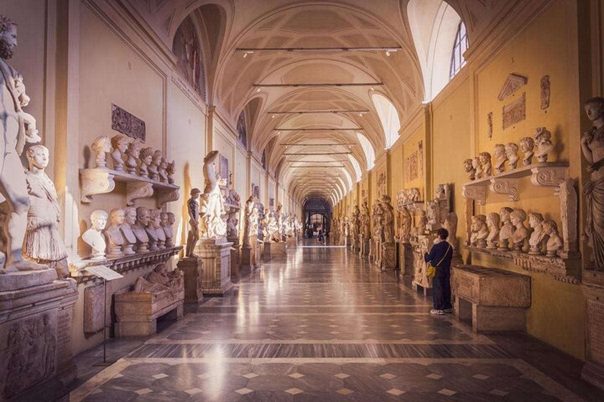 a hallway in a museum with lots of statues