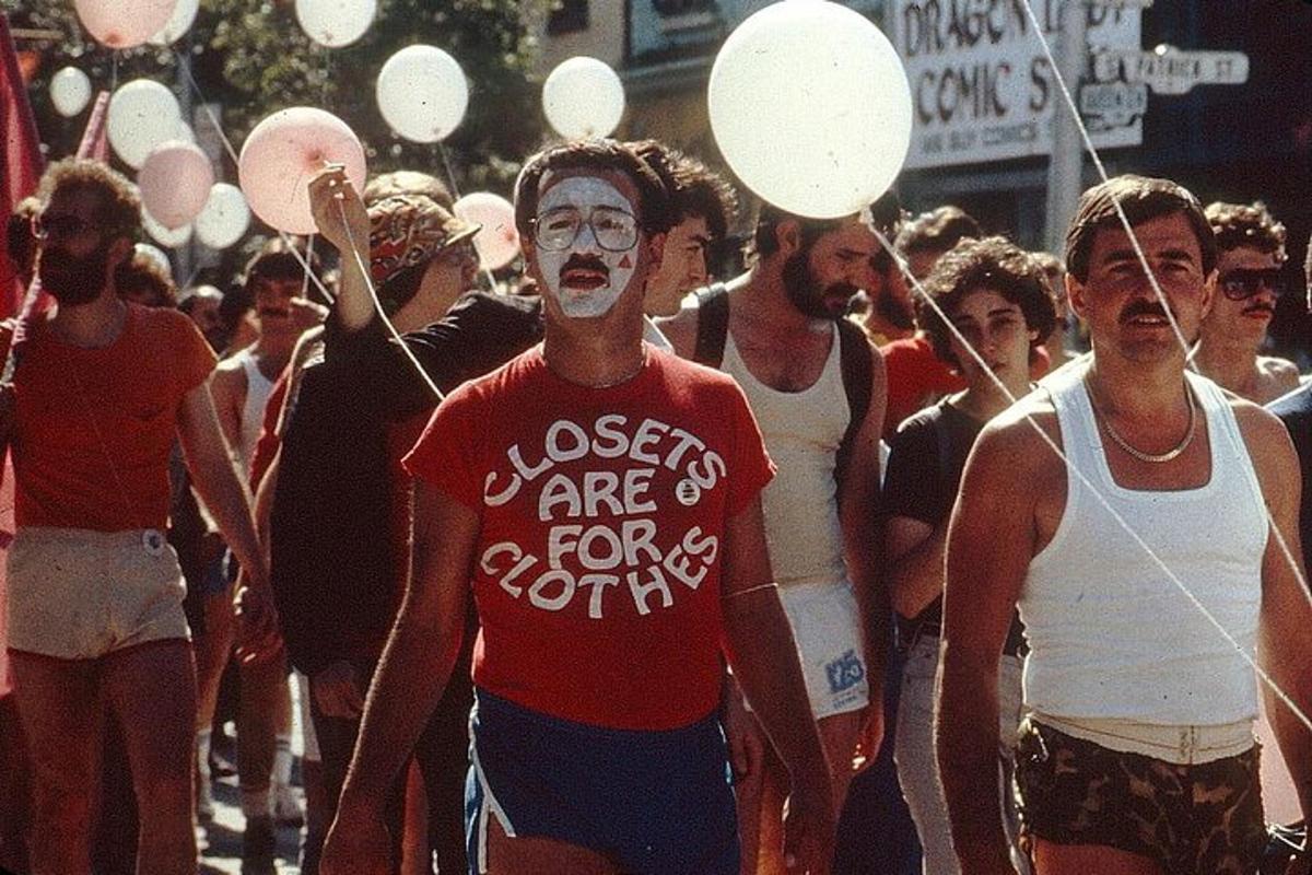 a group of people walking down a street with paint on their faces