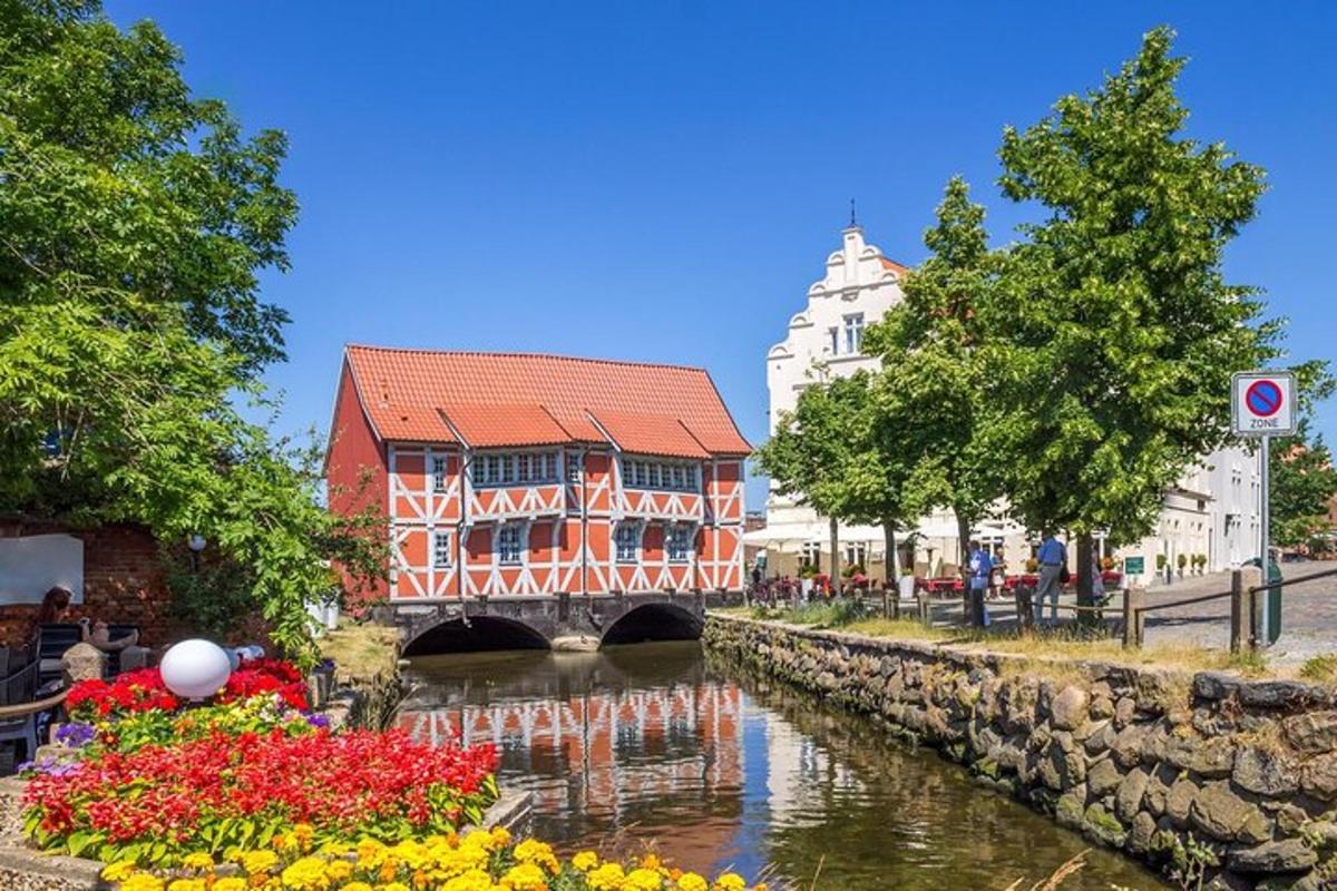 a bridge over a river in a city with flowers