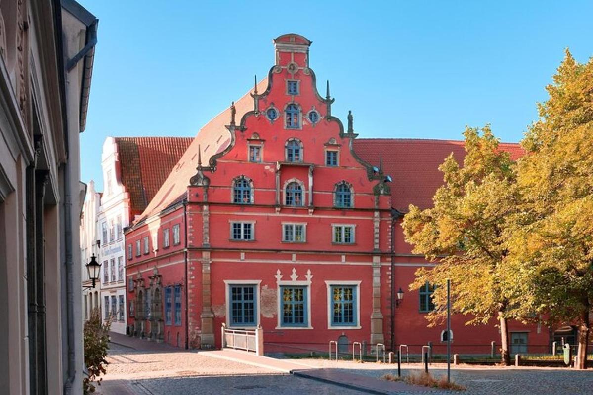a large red building with a tower on a street