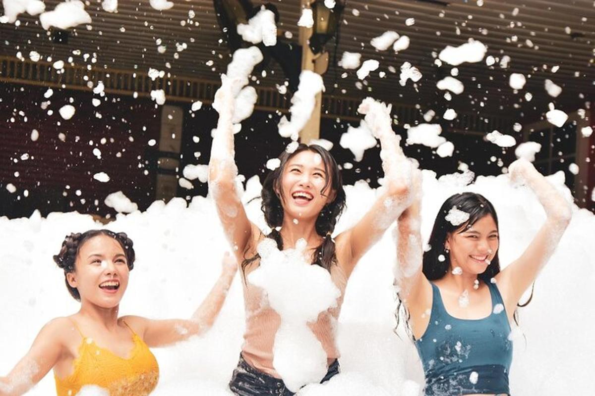three women are throwing snow in the air