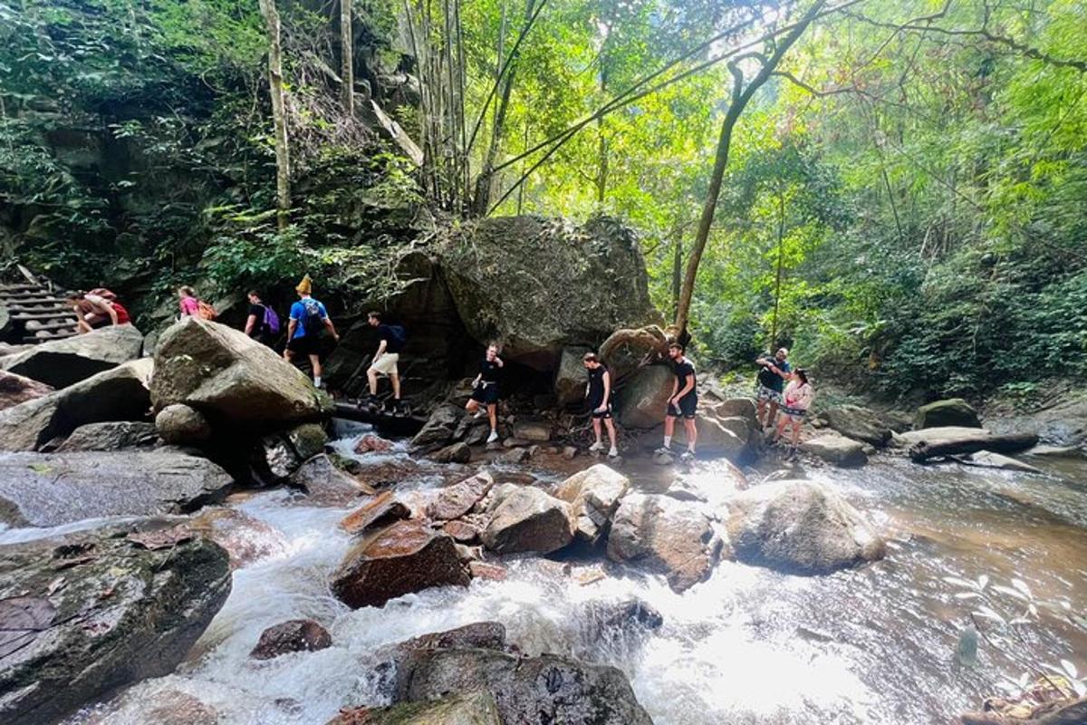 a group of people standing on rocks in a river