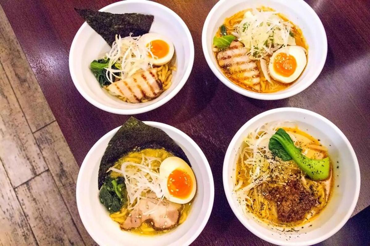 a group of four bowls of food on a table