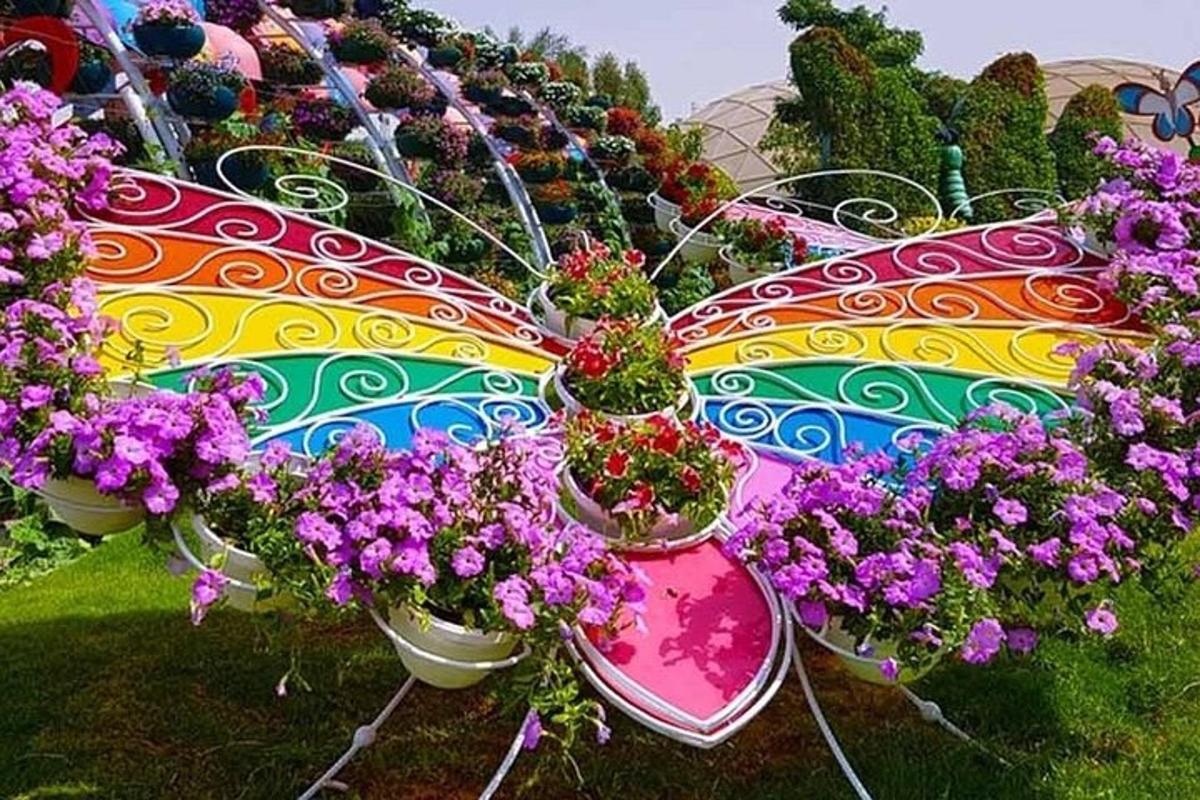 a colorful butterfly umbrella with flowers in pots