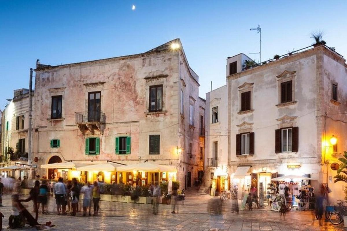 a group of people walking around a street with buildings