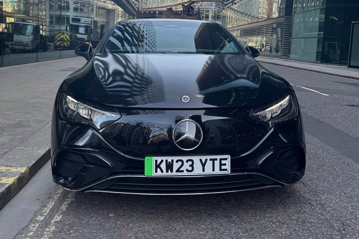 a black car is parked on a street
