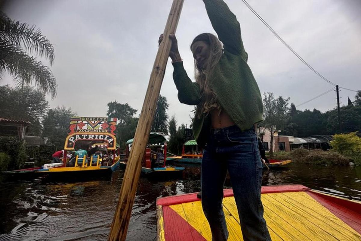 a woman is standing on a boat in the water