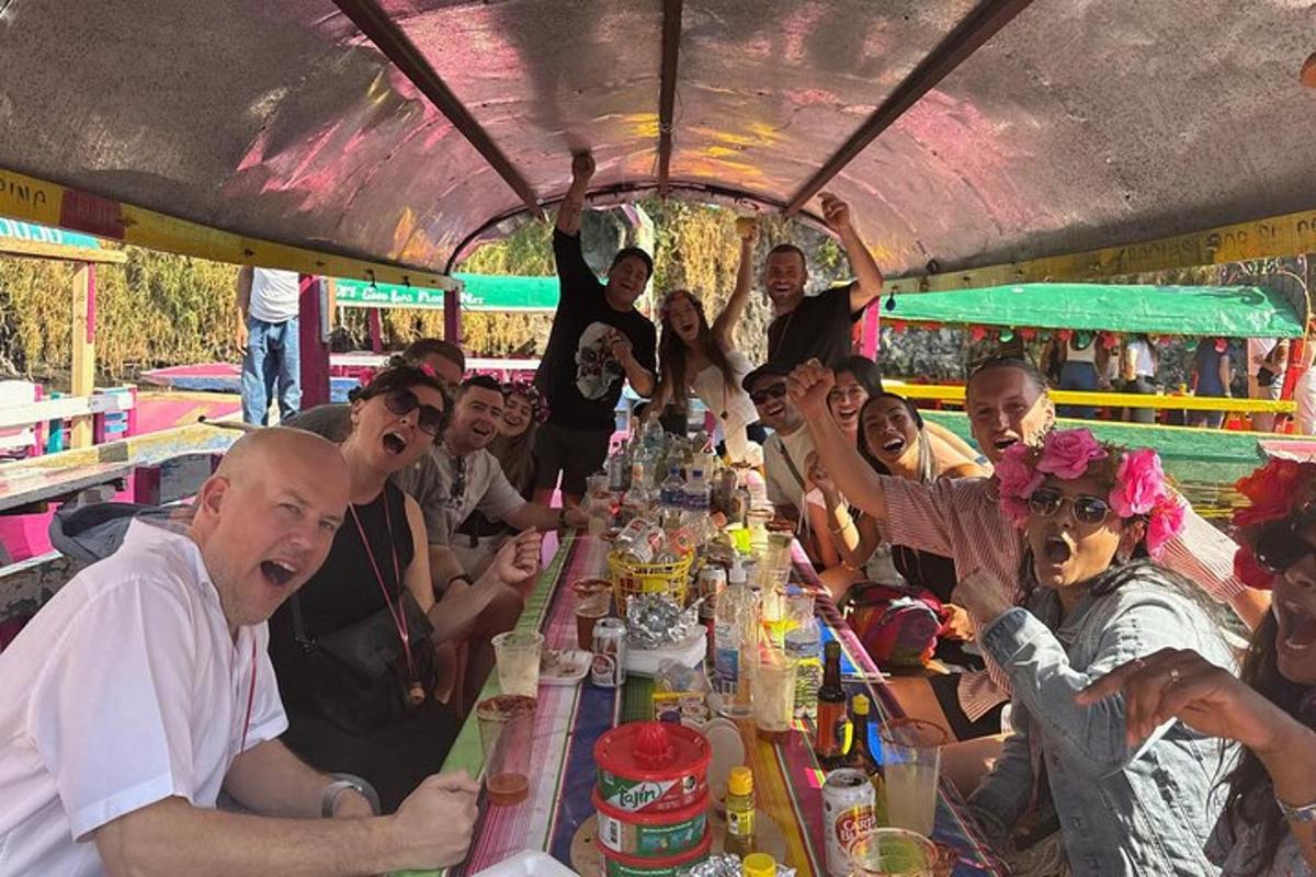 a group of people sitting around a long table with drinks