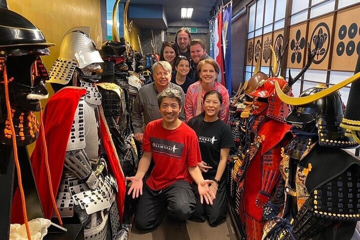 a group of people posing for a picture in front of armor