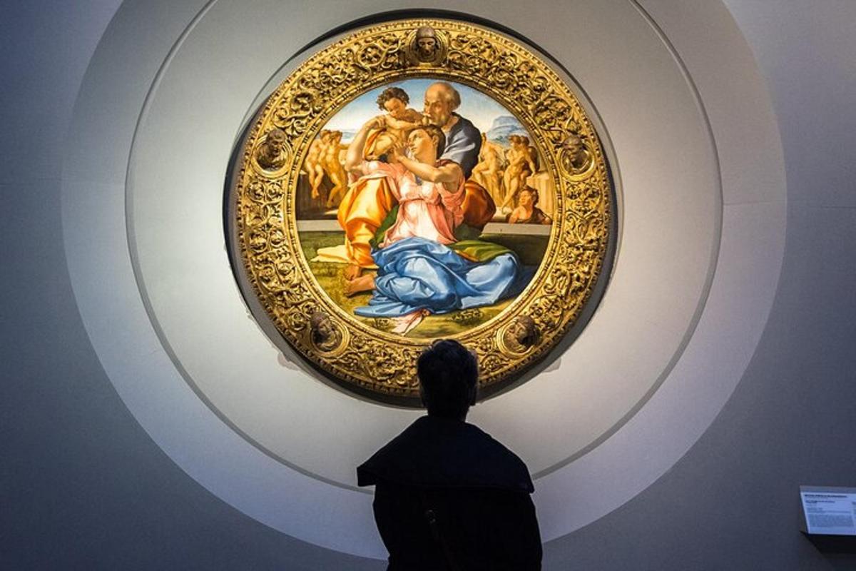 a person looking at a painting in a museum