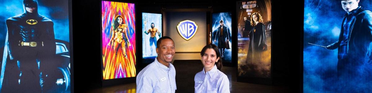 a man and a woman standing in front of some pictures
