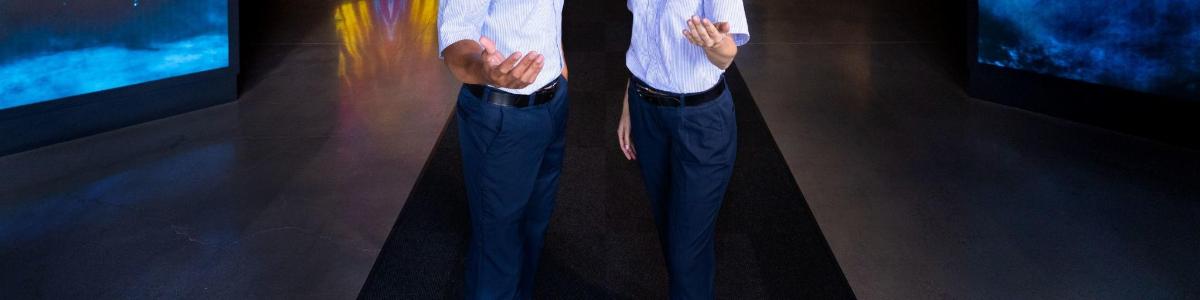 a man in a suit with his arms outstretched
