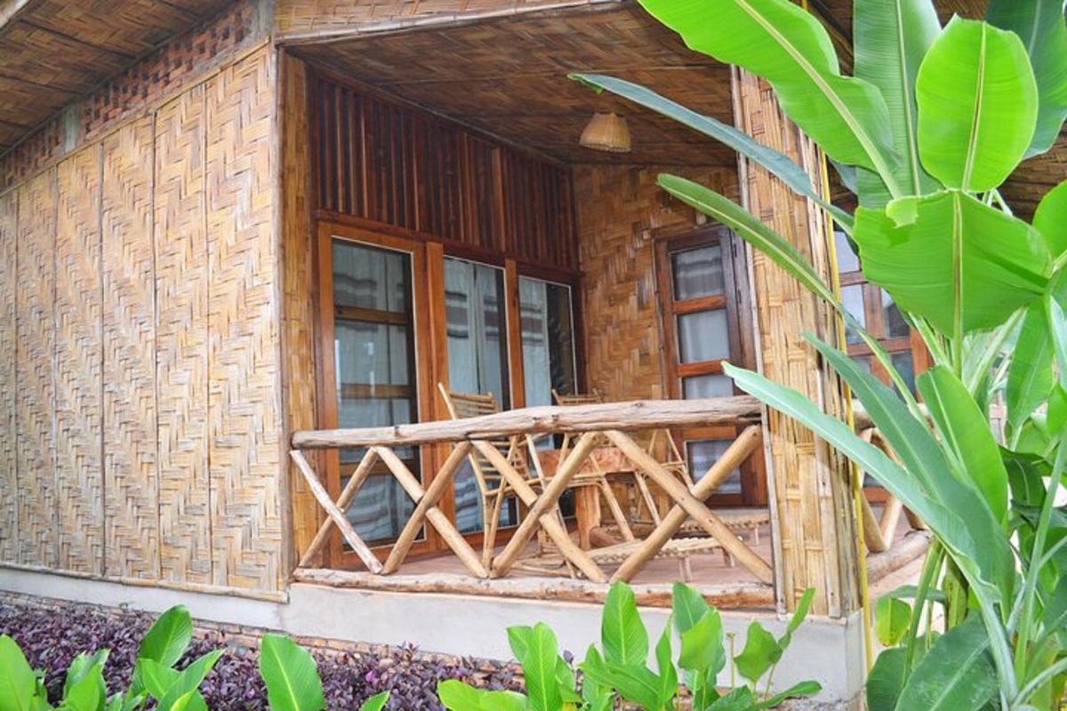 a wooden house with a balcony in front of it
