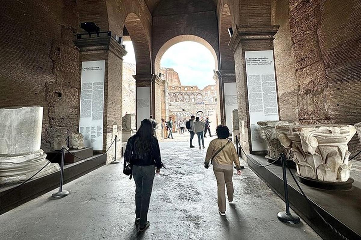 two people walking through a museum with ancient ruins