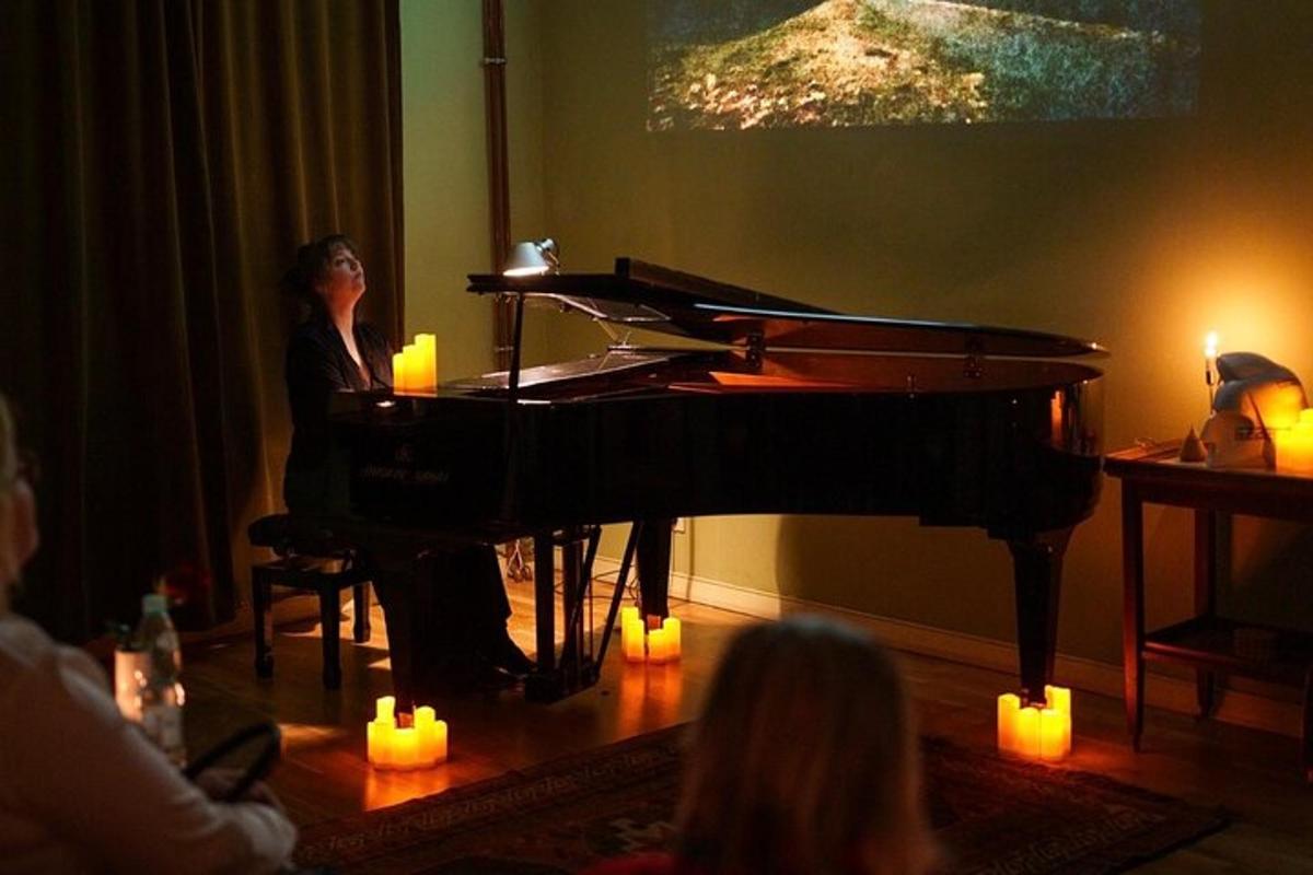 a woman sitting at a piano in a room with candles