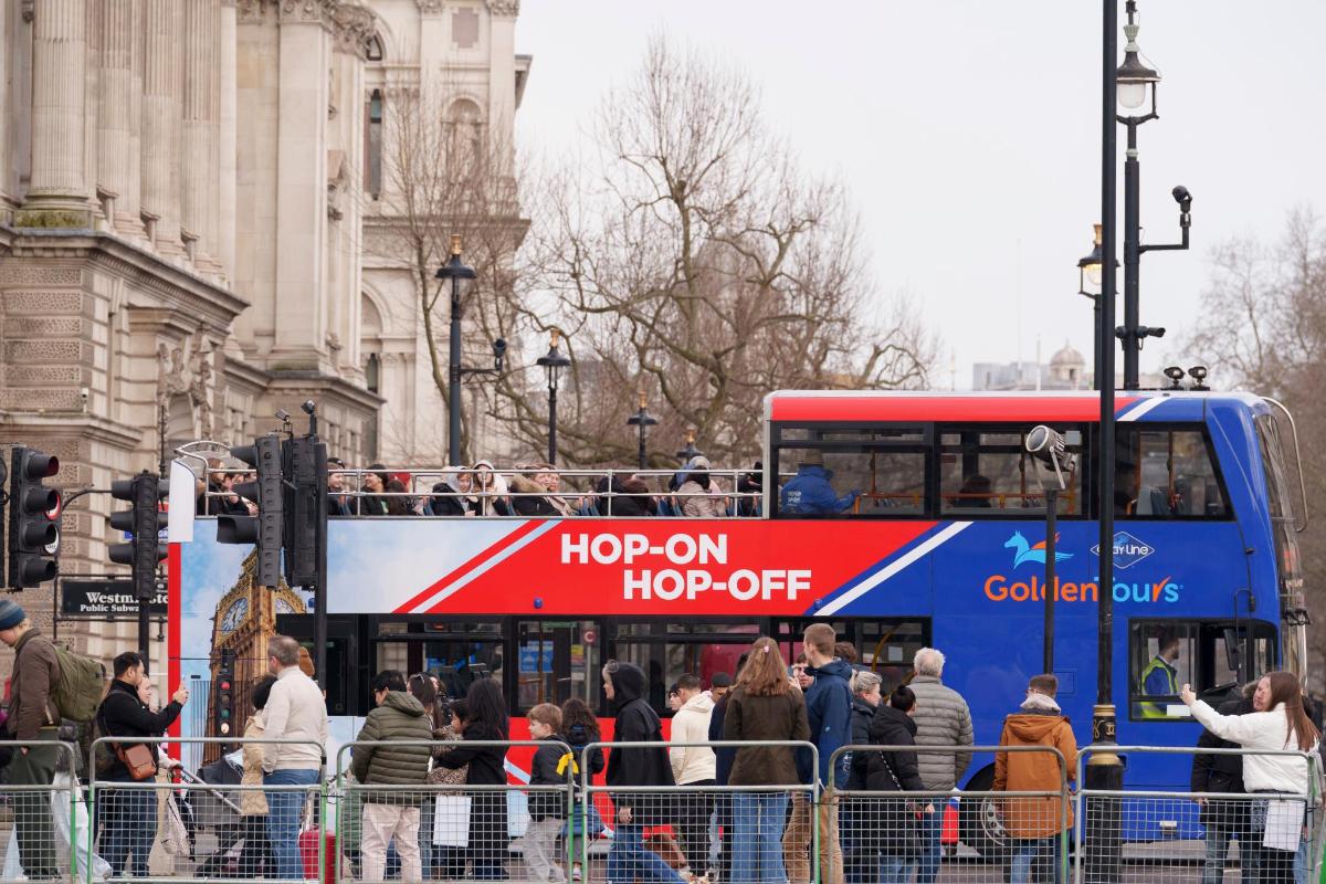 a double decker bus with a hop on hop off sign