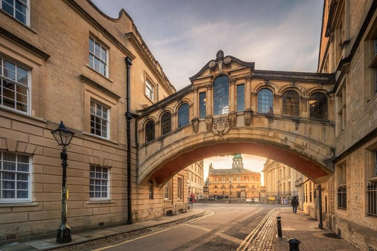 a bridge over a street in a city with a building