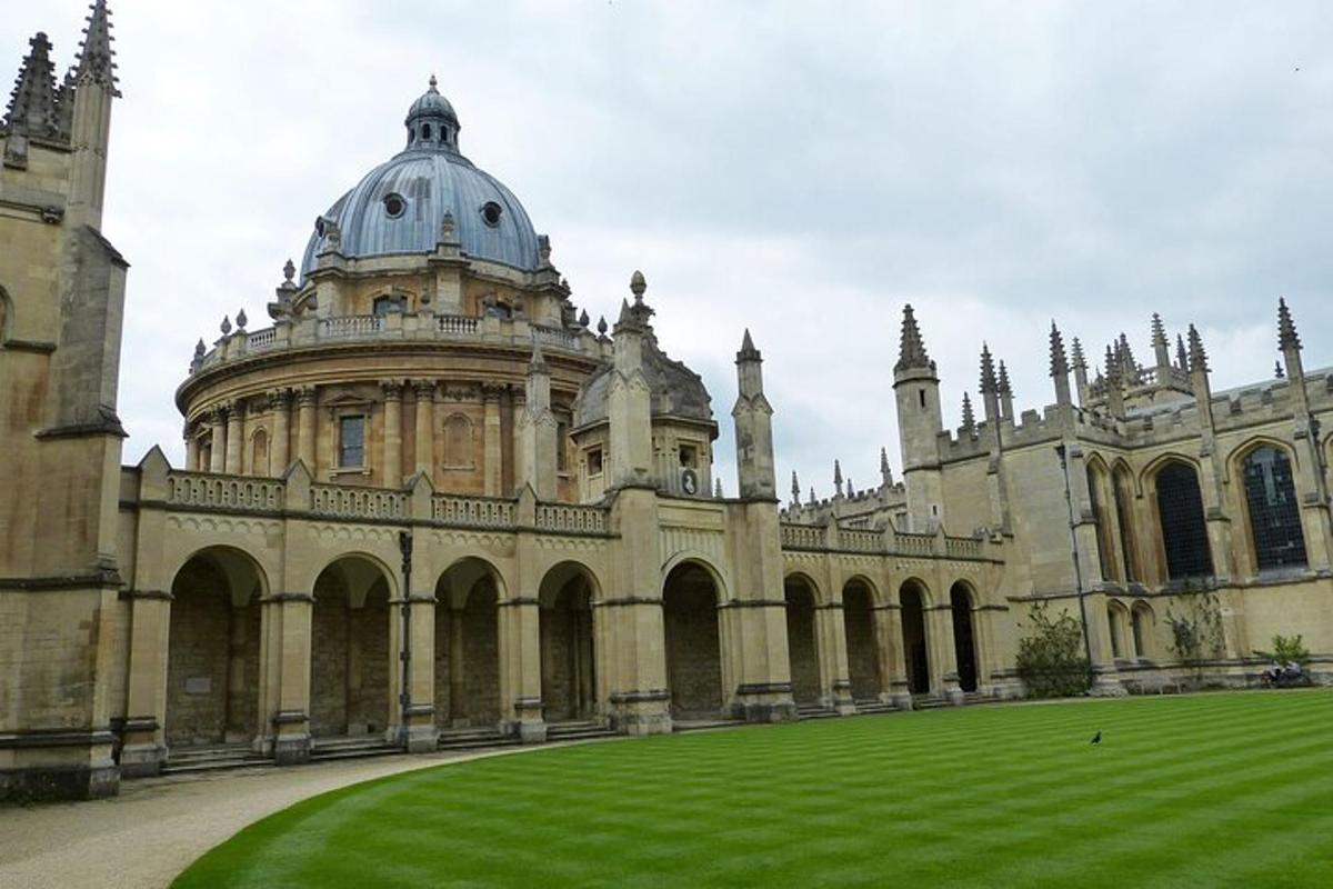 a large building with a grass field in front of it