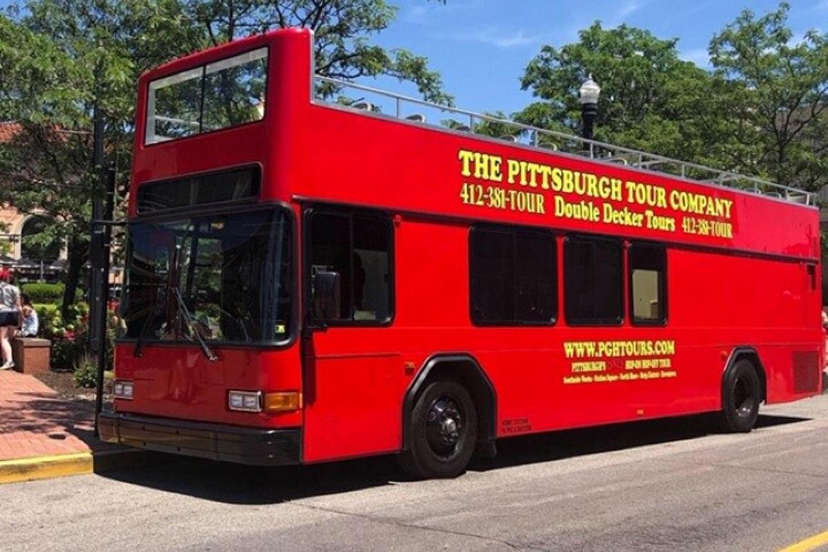 a red double decker bus parked on the street