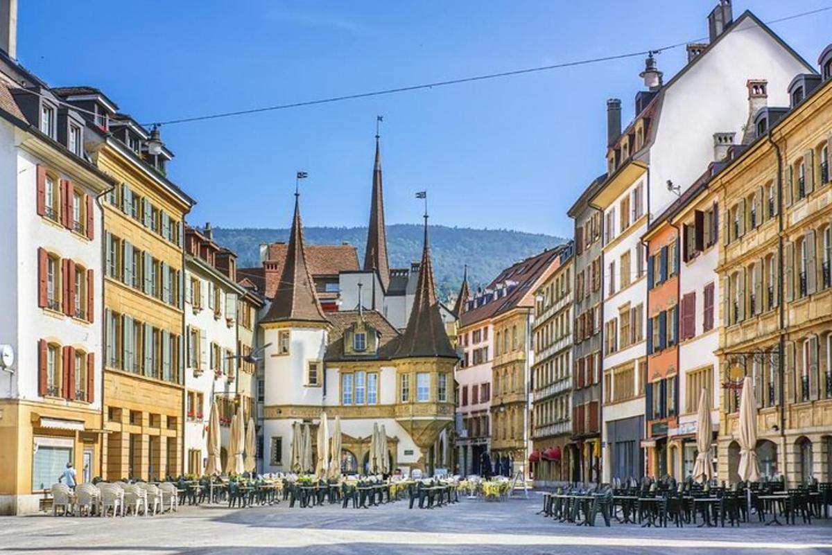a city street with tables and chairs and buildings
