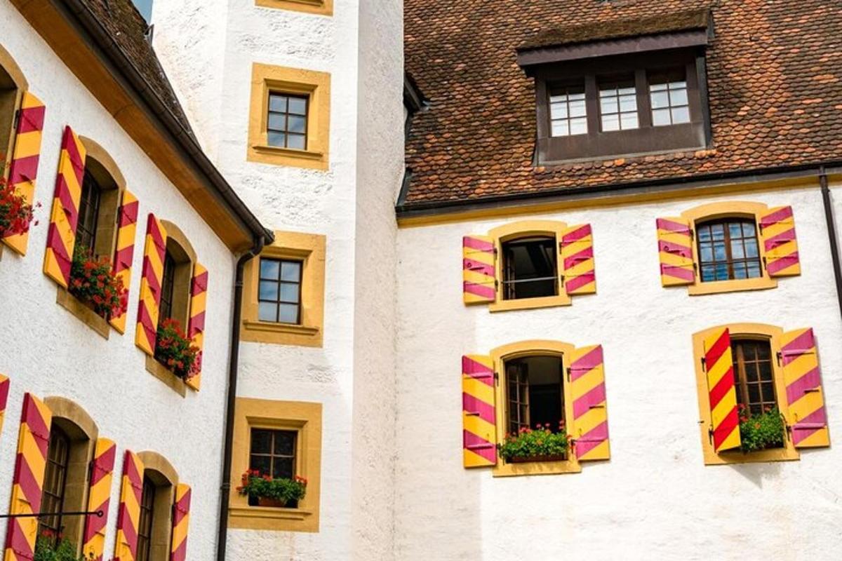 a building with colorful shutters and flowers on it