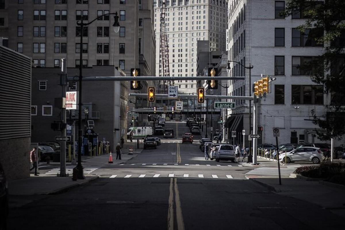 an intersection with traffic lights in a city with buildings