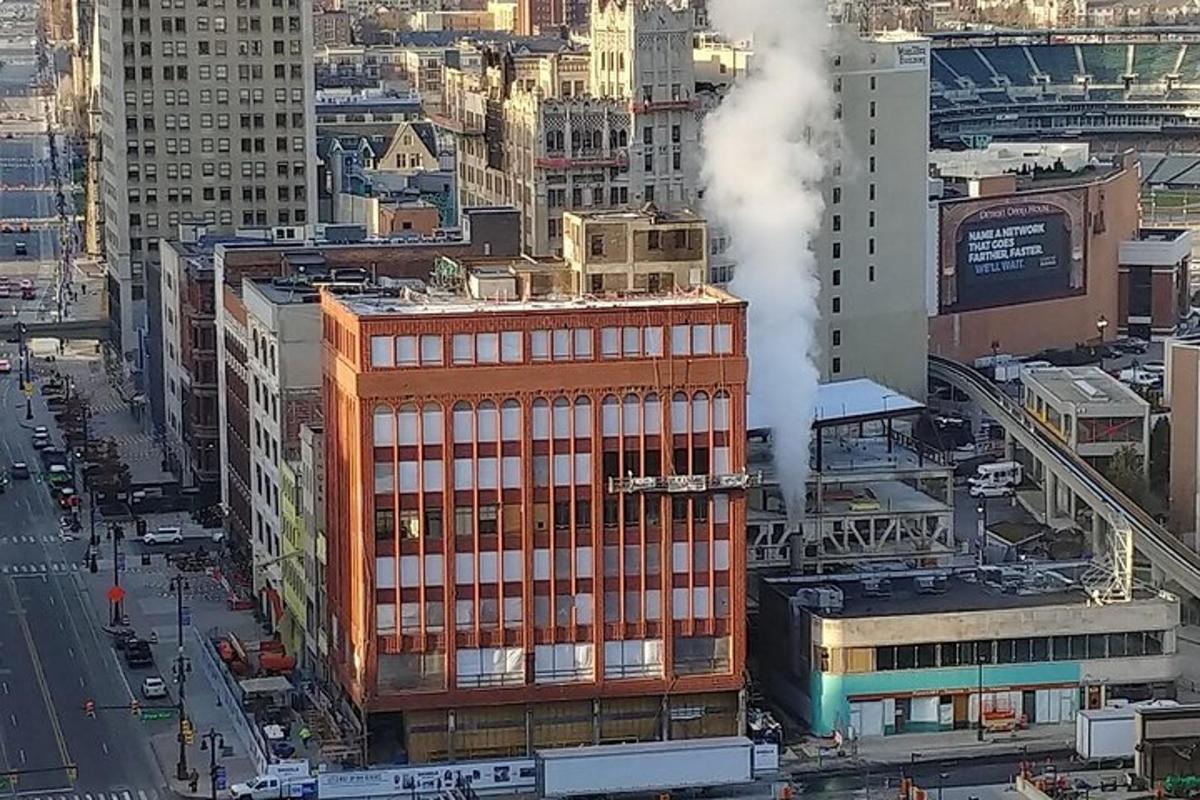 a building with smoke coming out of it in a city