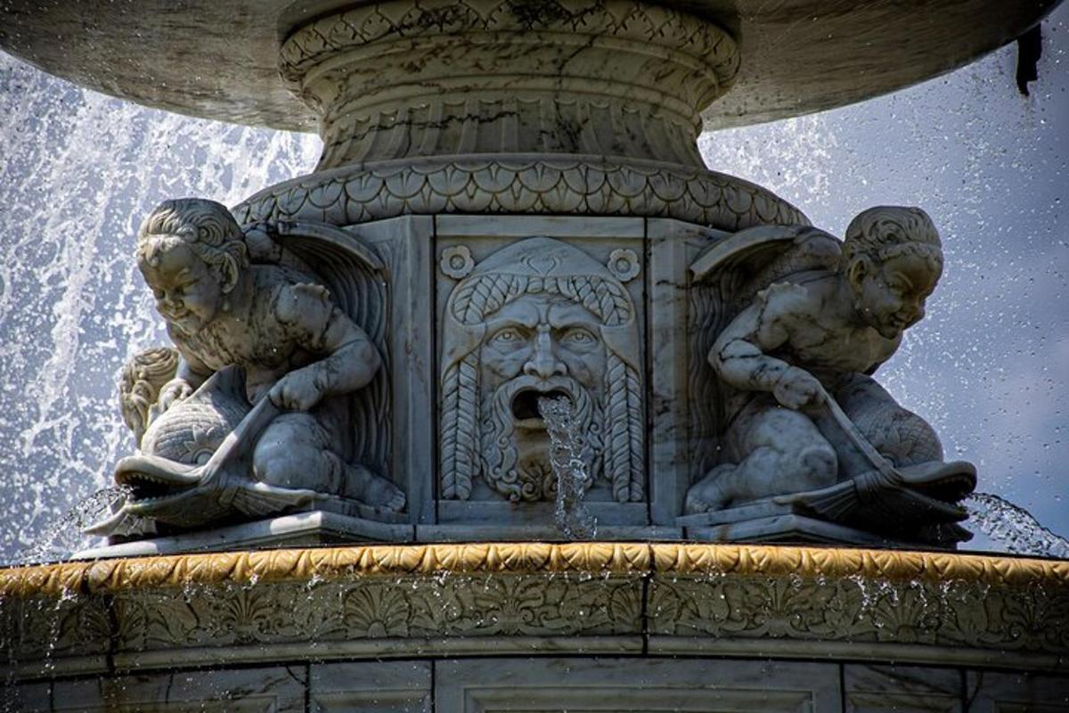 a statue of two cherubs on top of a fountain