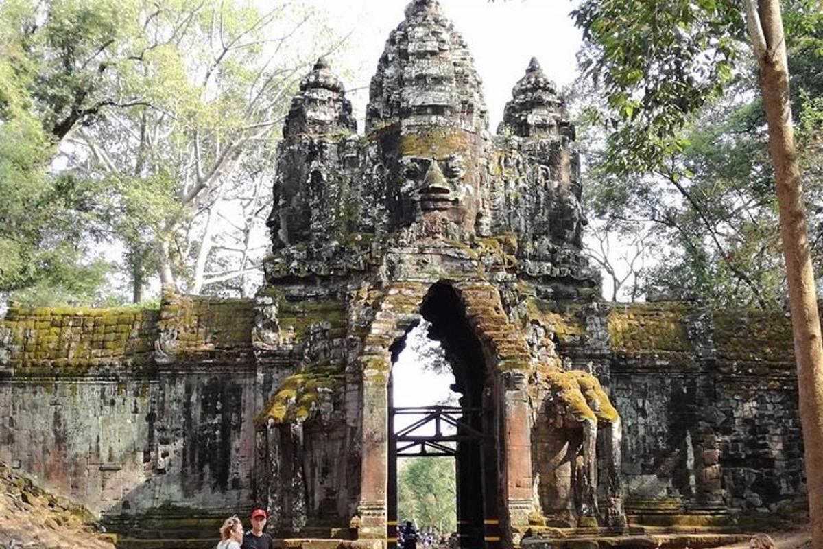 a gate to an ancient building with a statue