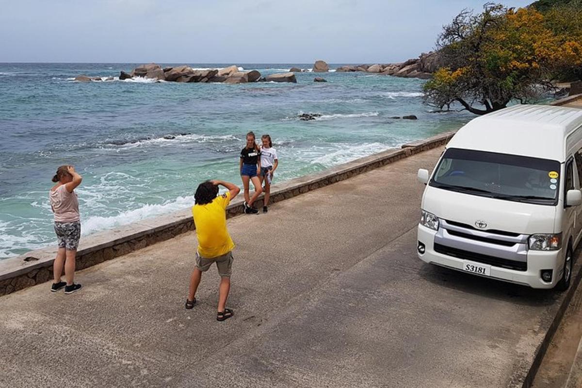 a group of people standing on a road next to a van